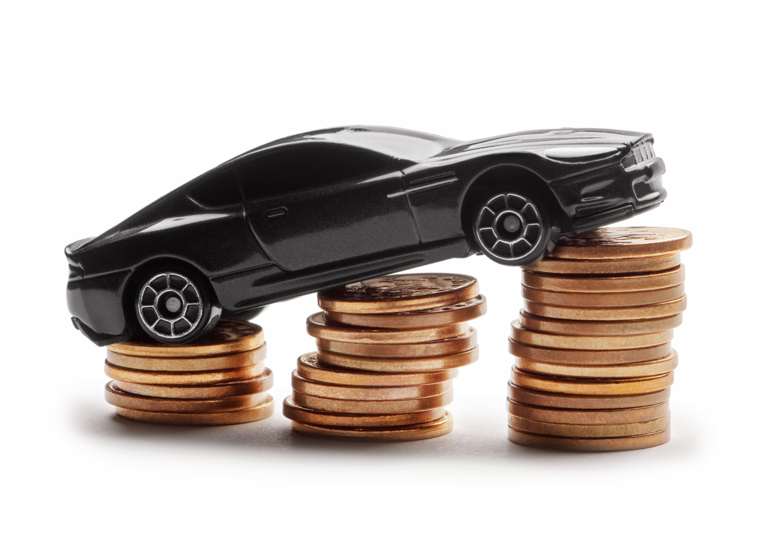 Toy car on stacked coins indicating rising costs of car insurance
