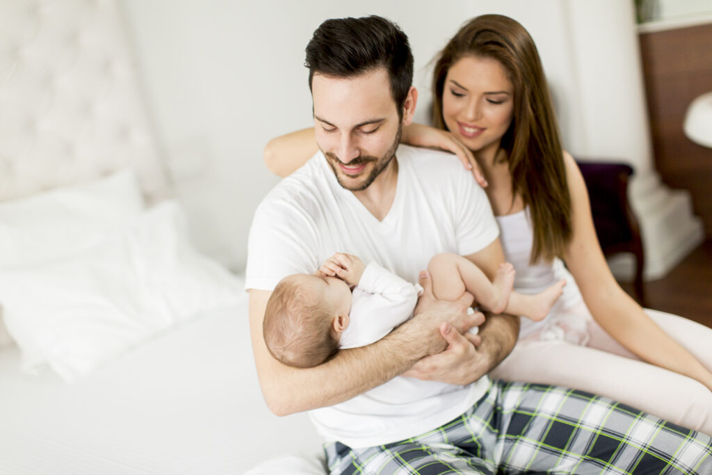 Young parents holding newborn