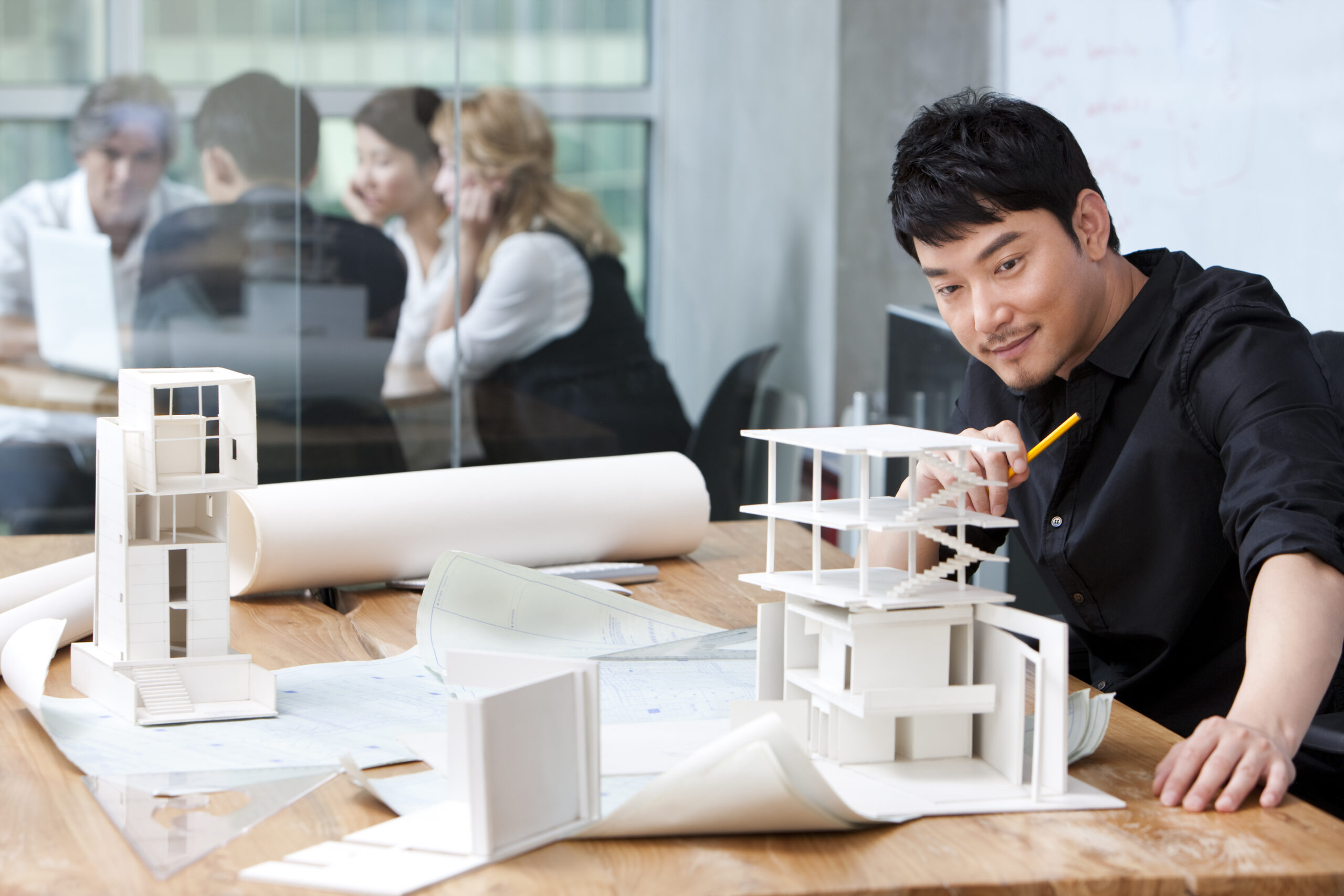 architect looking at model of building