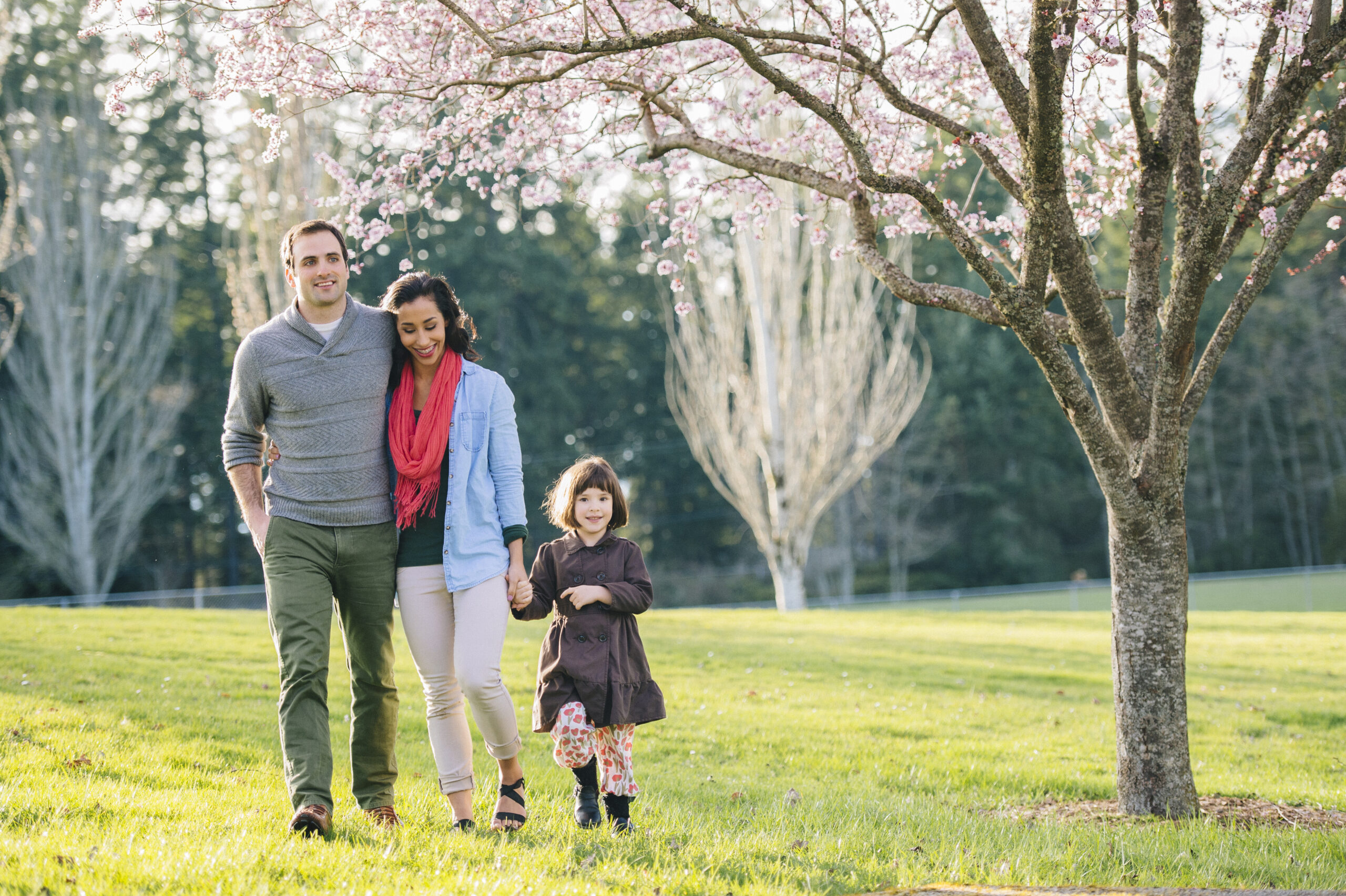 Couple walking with daughter in park