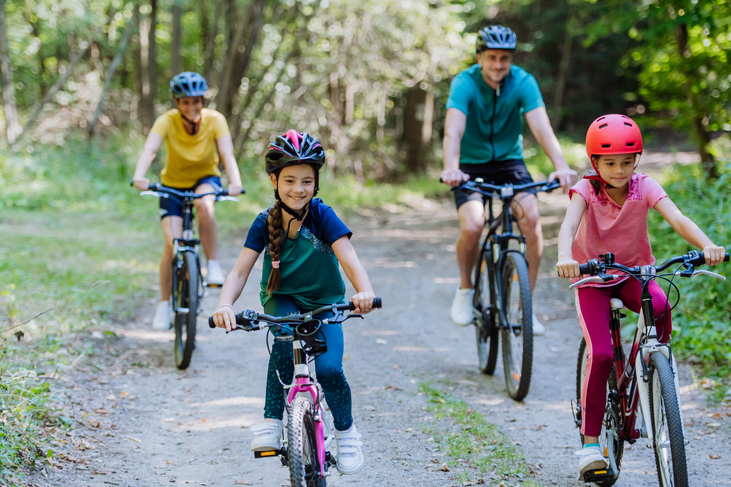 Family riding bikes on trail