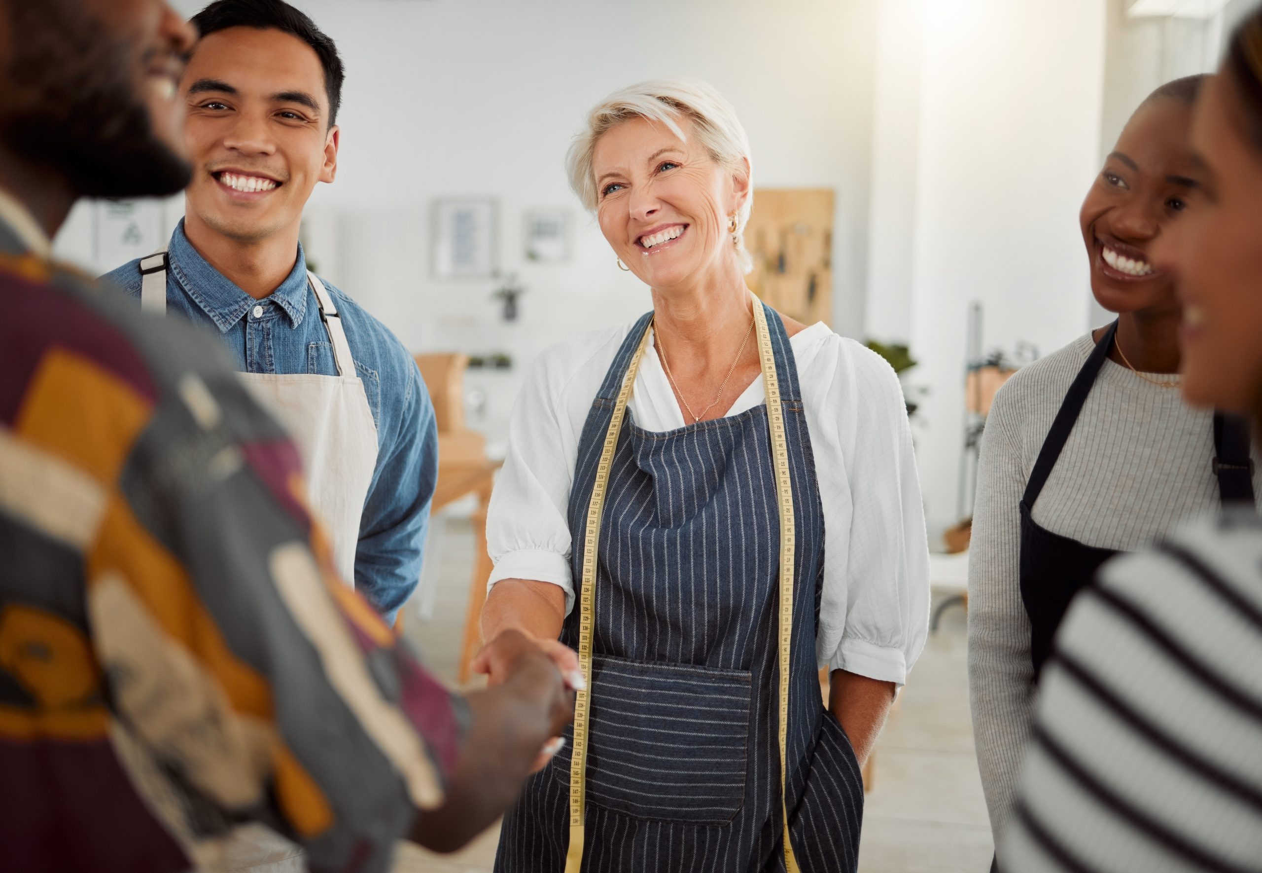 business owner shaking hands with employee