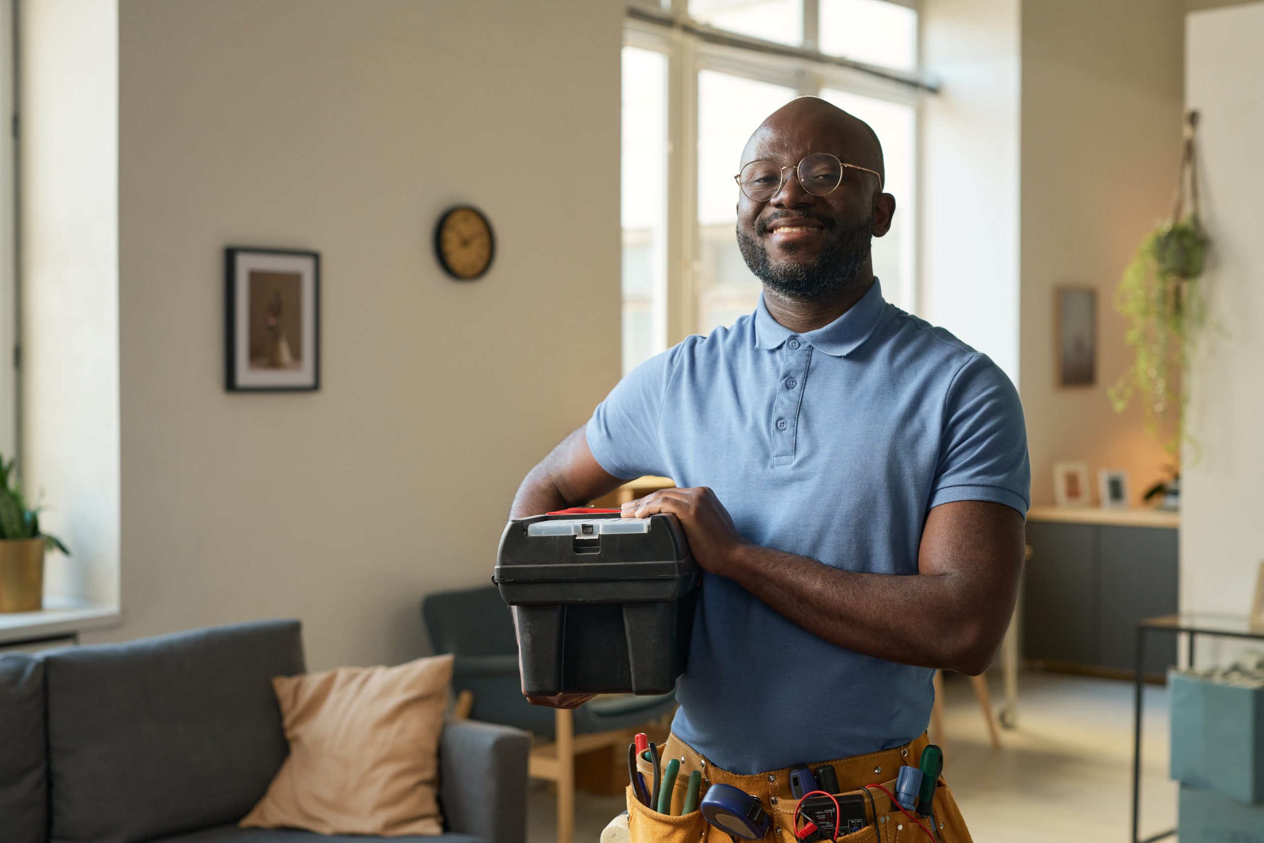 smiling handyman with toolbox