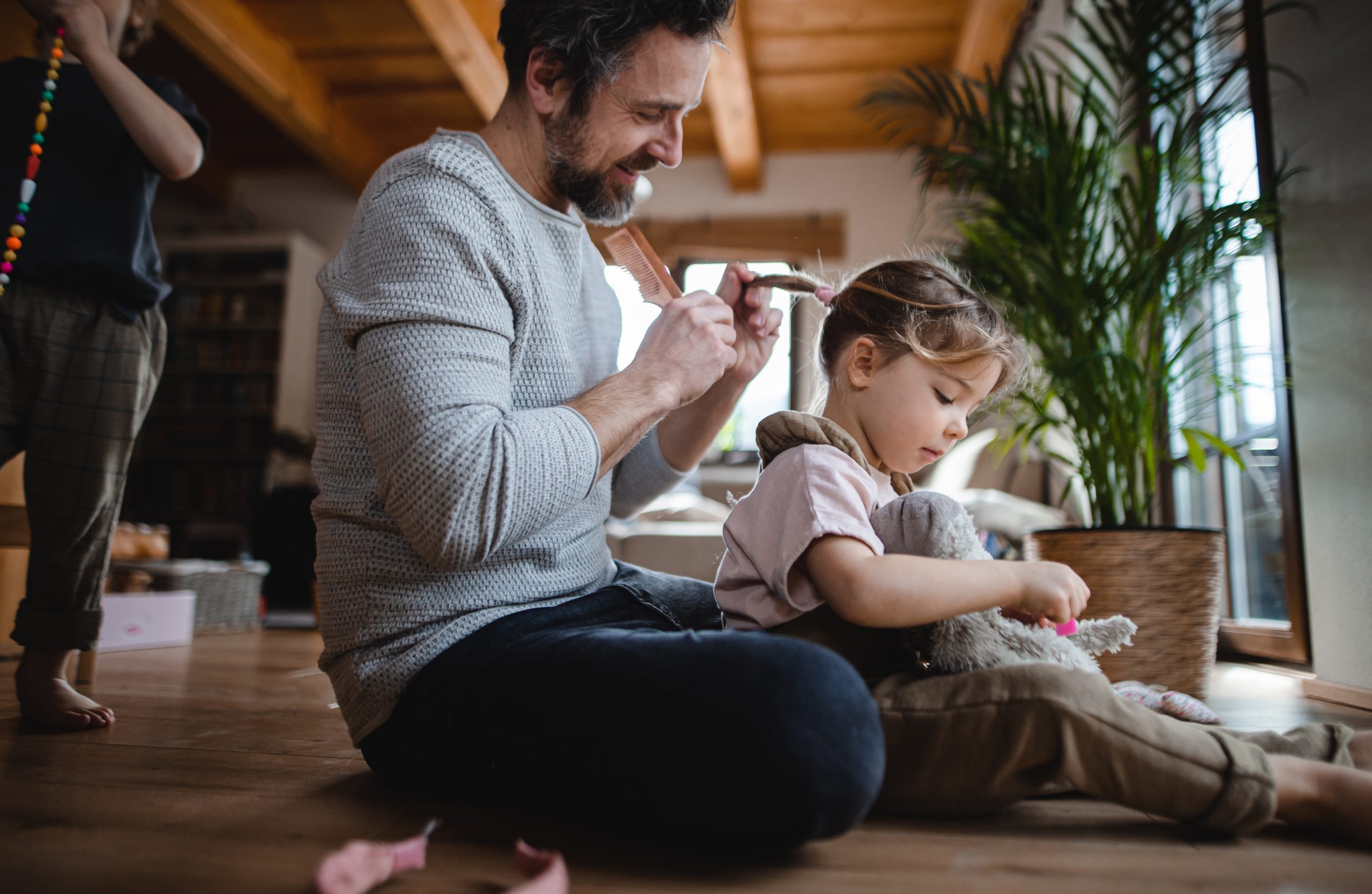 dad brushing daughter's hair