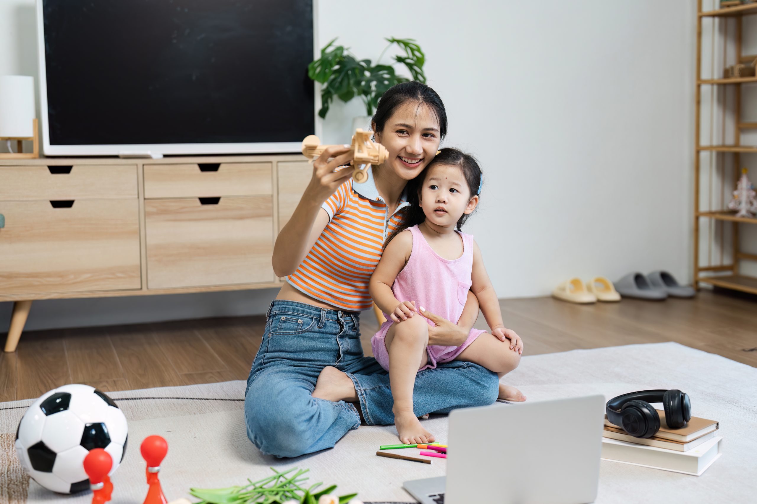 mom playing with child on floor