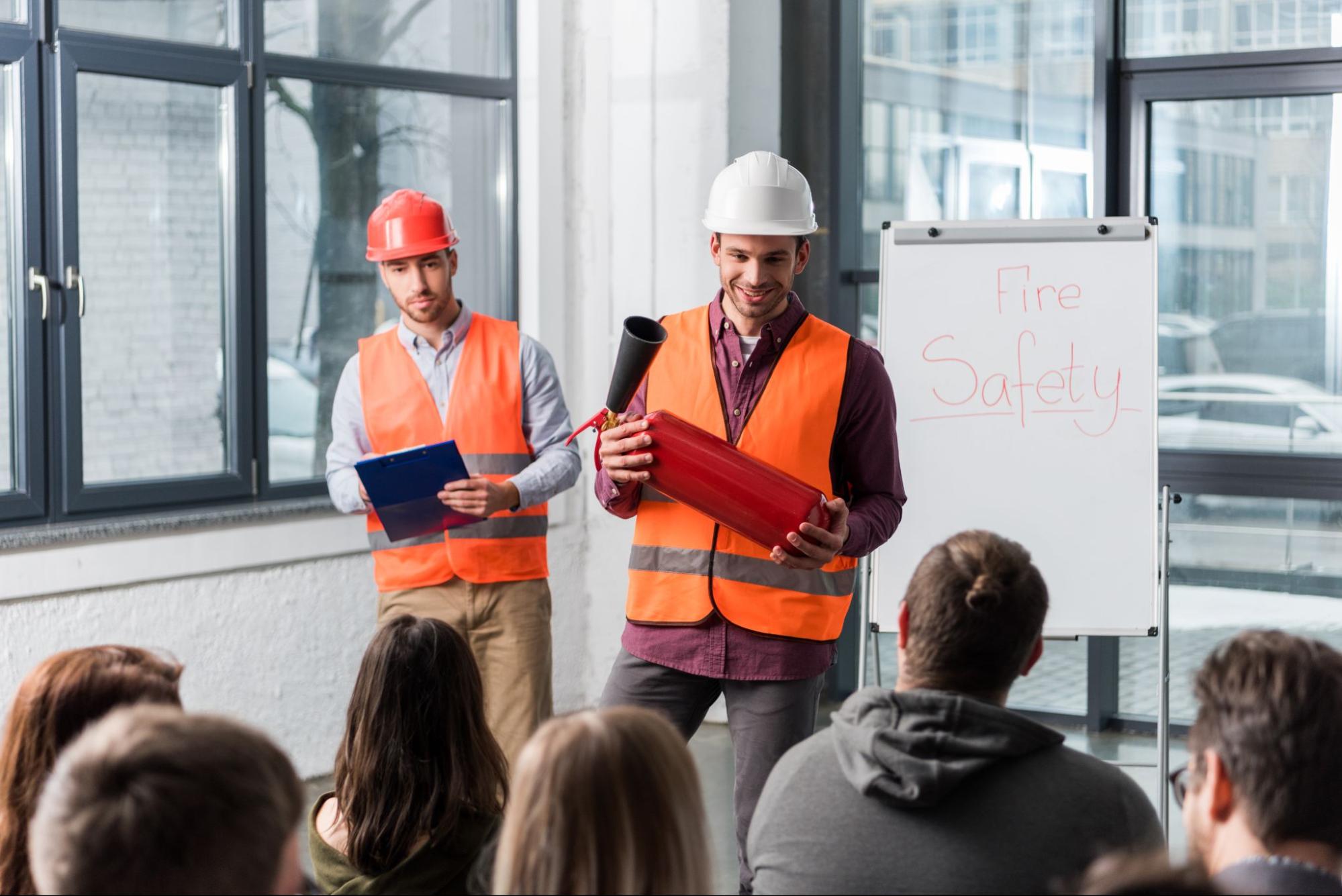 Managers in hard hats leading company meeting