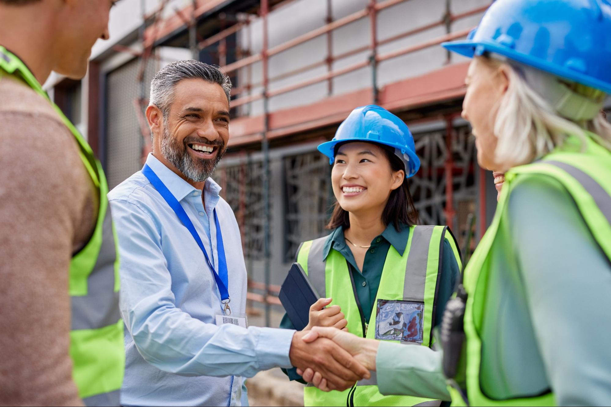 manager shaking hands with women on team