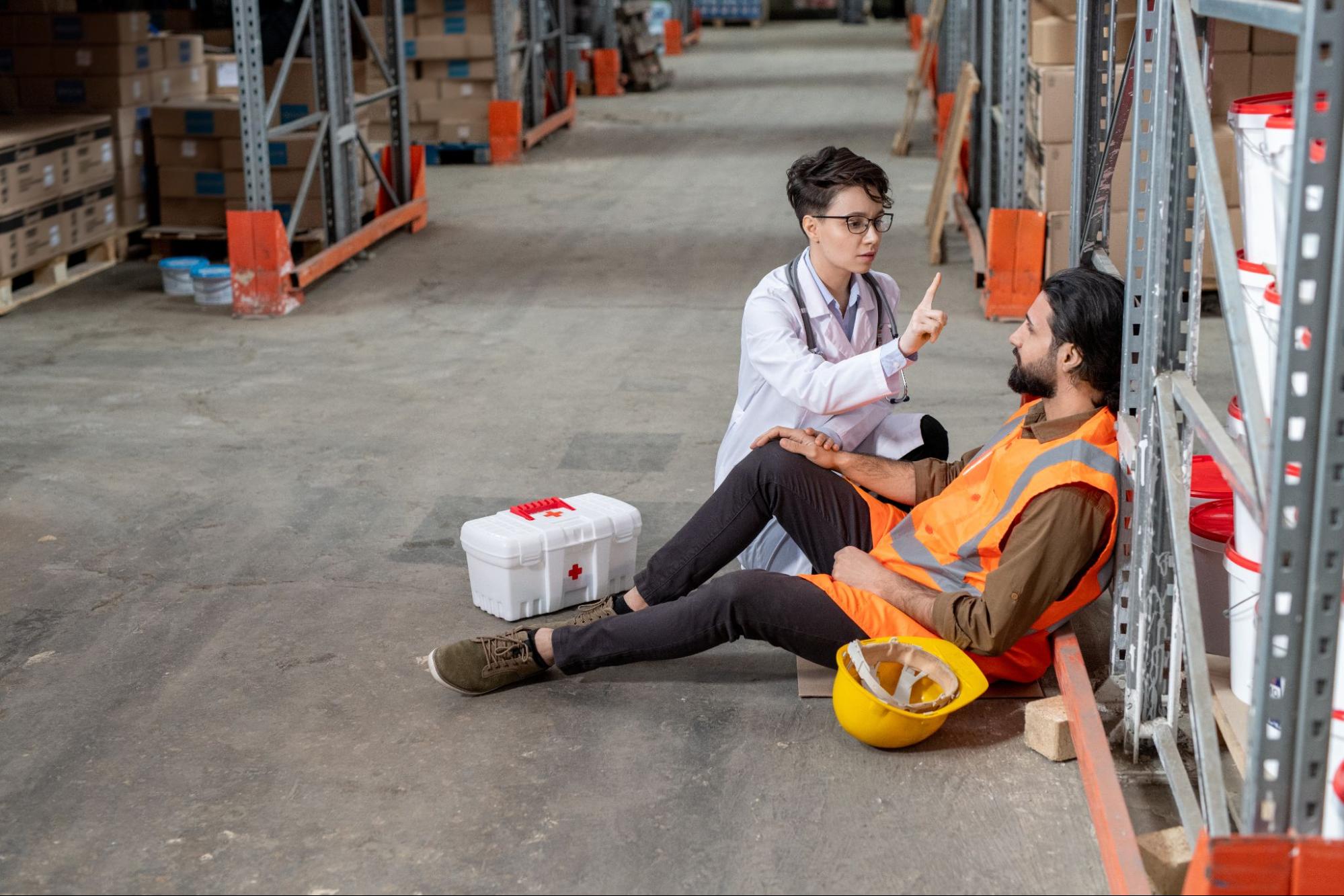 doctor treating injured warehouse employee